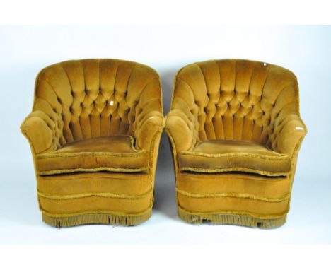 A pair of button back armchairs upholstered in dark mustard velour, height 80cm