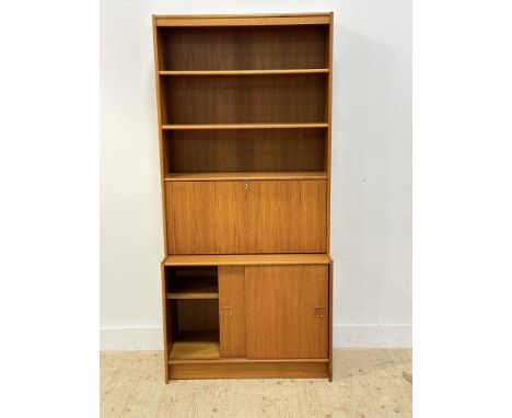 A teak veneered two part cabinet with open shelves and fall front drinks section, with sliding doors to base (h.187cm x l.88c