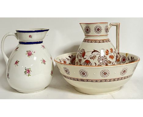 A transfer printed Aesthetic Movement jug and basin decorated in orange with typical floral motifs (marked "Derby" verso, h- 