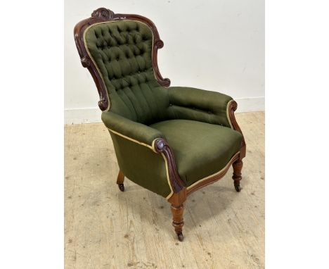 A Victorian mahogany easy chair with button back in green fabric on turned feet with original brass caps and china castors: h