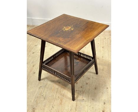 An Edwardian rosewood two tier lamp table on pierced splay supports (h. x 63cm l.x 58cm w. x 58cm)