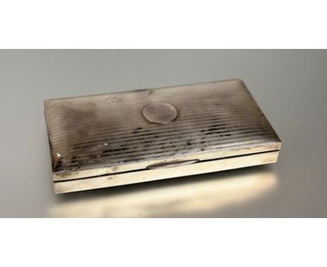 An Edwardian Birmingham silver ceder lined cigarette box with linear engine turned decoration: h. x 2.3cm l. x 16.5cm w. x 8c