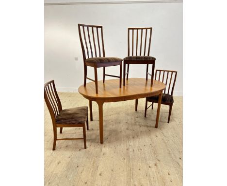 A 1980s MacIntosh of Kircaldy teak kitchen/dining suite comprising table and four shaped spar back chairs (table: h.77cm x l.