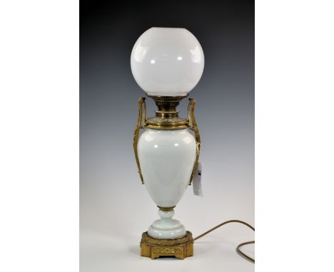 A Victorian opaline glass and gilt brass two handled vase oil lamp, converted to electricity, with later milk glass globe sha