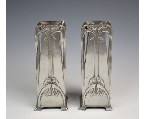 A pair of W.M.F polished pewter vases, of tapering rectangular form with stylised Art Nouveau long stem floral decoration, on