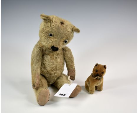 A miniature Schuco or Steiff bulldog, 5in. (12.8cm.) high, together with a vintage teddy bear. (2)