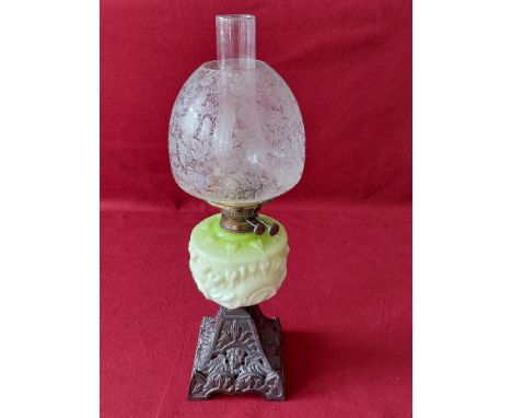 Victorian oil lamp cast iron base and green china reservoir.