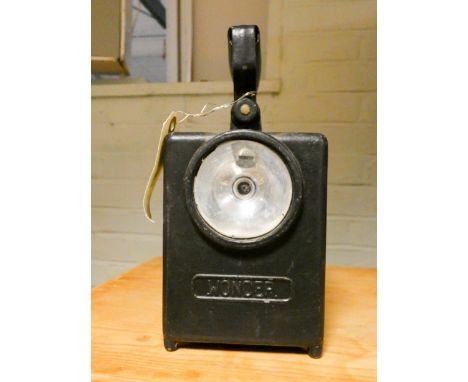 A French railway signalling lamp and a carved native wood figure 