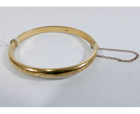 A 9ct yellow gold ladies hinged bangle with safety chain 6.5gms 