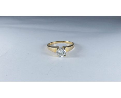 A diamond solitaire ring set with a circular brilliant cut diamond weighing approx .75 of a carat on a 14ct yellow gold setti