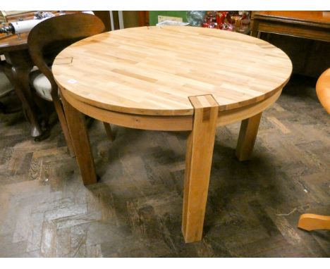 Circular light oak parquetry topped dining table on heavy square legs 