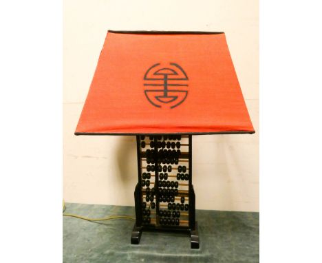 A Chinese Abacus table lamp with orange shade 