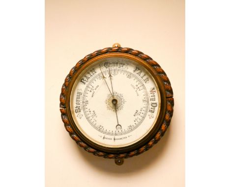 A circular wall barometer in oak rope patterned case 10" diameter 