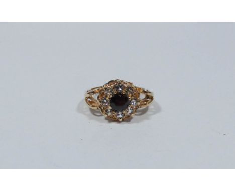 A garnet and CZ dress ring in a 9ct gold setting, ring size J 