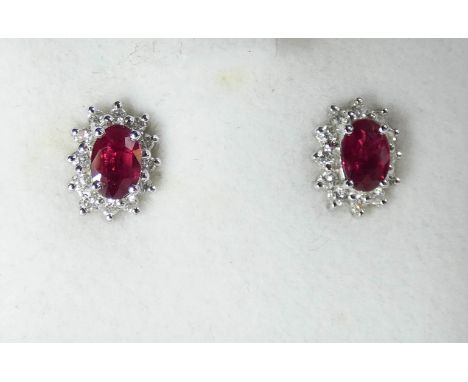 A pair of 18 ct white gold ruby and diamond cluster earrings with a copy of insurance valuation from Charles Nobel County Jew