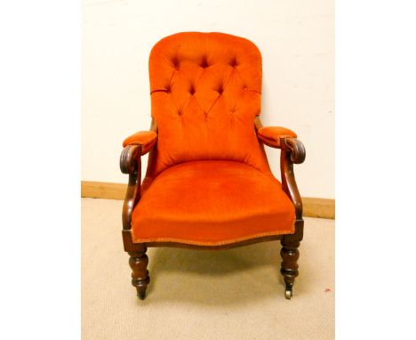 A Victorian mahogany framed terracotta upholstered elbow chair with button back 