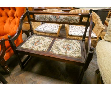 A small wood framed two seater hall settee with tapestry upholstered seats and back 