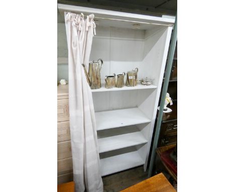 A white painted open shelf unit with curtain 3' wide 