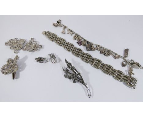 A vintage paste set bracelet, marcasite brooches, deco clips and a silver charm bracelet