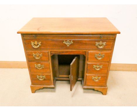 Edwardian style mahogany kneehole pedestal desk fitted one long, six short drawers and cupboard centre standing on bracket st