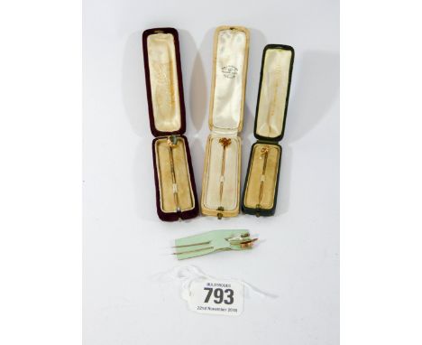 A collection of five Victorian stick pins, to include Welsh dragon enamelled example, three cased.