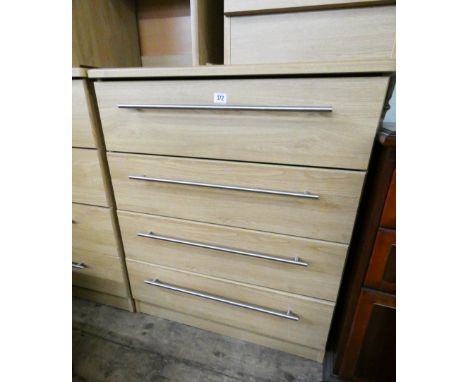 A modern light oak finished chest of four long drawers 2'6 wide matching the previous lot 