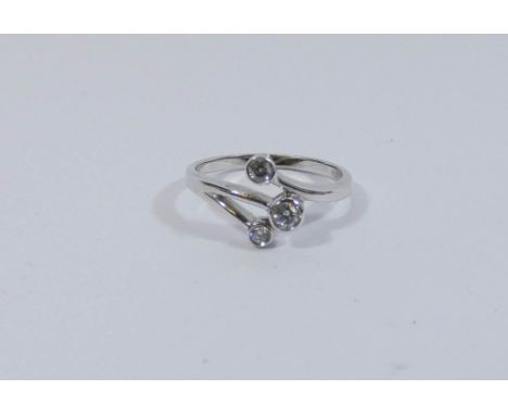 A 9ct white gold three stone diamond ring of modern design, ring size N 