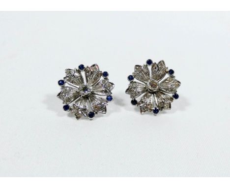A pair of vintage sapphire and diamond flower cluster ear studs, flower set with a central brilliant cut diamond in four claw