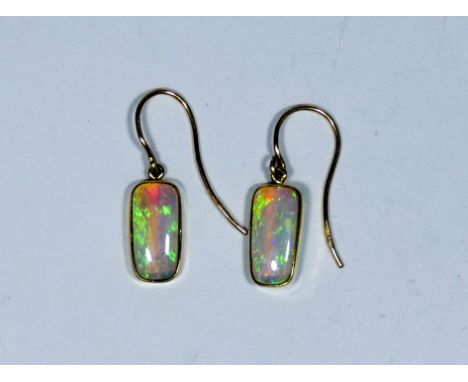 A pair of Edwardian opal drop earrings, the rectangular opals displaying good colour and vibrancy on 9ct rose gold wires, app