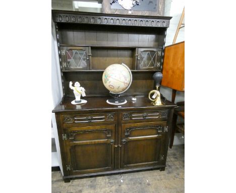 A 4' reproduction oak Welsh style dresser with small lead light cabinets in the back 