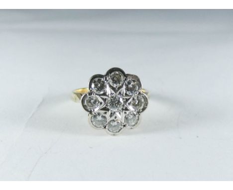 A diamond daisy flower head cluster ring on an 18ct gold shank ring size K 