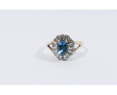 A 9ct gold blue topaz and diamond oval cluster ring, ring size L 