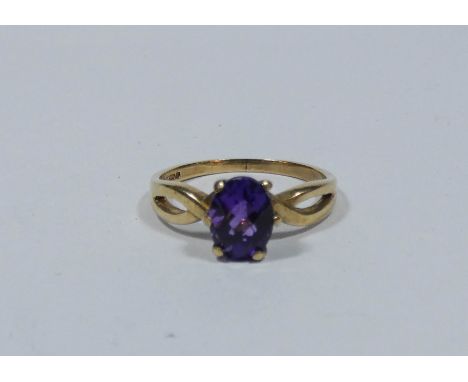 An amethyst ring on a 9ct yellow gold claw setting, ring size O 