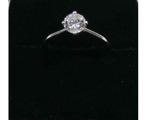 A solitaire diamond ring, set with a circular brilliant cut diamond weighing approximately 60 points, claw set in raised Amer