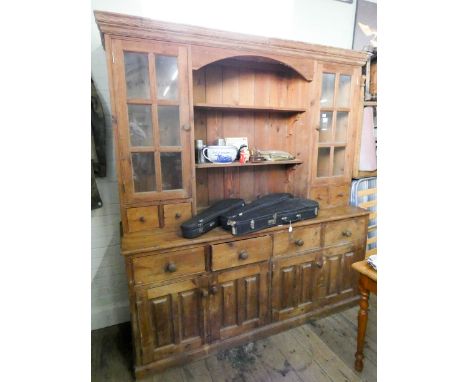 A pine kitchen dresser with glazed and shelf back with spice drawers standing on a four drawer and cupboard base 6'3 wide 