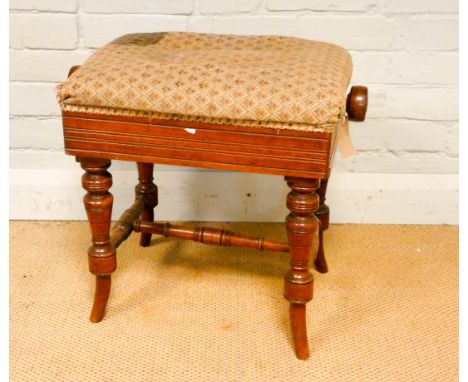 A late Victorian walnut adjustable music seat with tapestry cover 