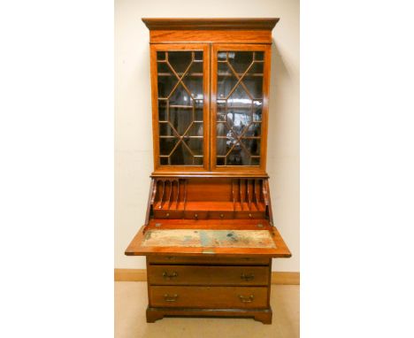An Edwardian inlaid mahogany bureau bookcase with double glazed lattice doors, partly fitted interior with three long and two