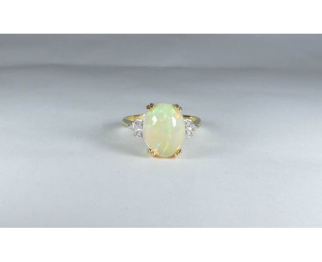 Opal and diamond ring the large oval opal claw set with diamond shoulder on hallmarked 18ct gold shank, ring size O