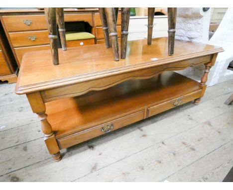 A two tier long teak finished coffee table with the lower shelf fitted two drawers  