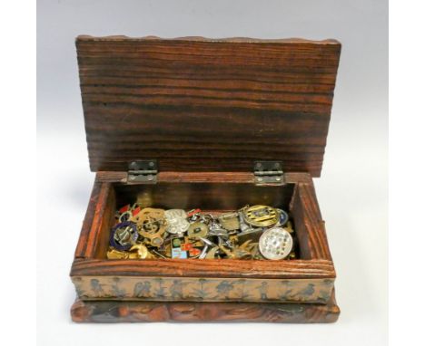 Various military and enamel badges in an old pine cigarette box 
