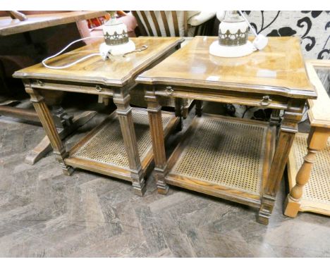 A pair of walnut two tier lamp tables with pull and slides and cane under tier 