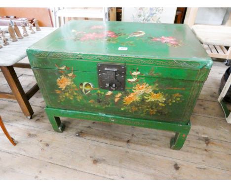 A green painted bird and floral decorated storage trunk 