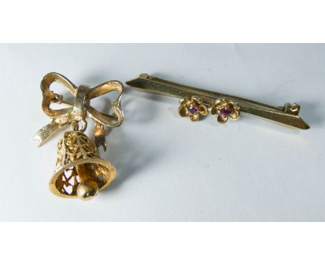 A 9ct yellow gold Christmas bell brooch and a ruby set flower design bar brooch 