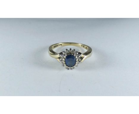 A 9ct gold oval sapphire and diamond cluster ring, ring size P 