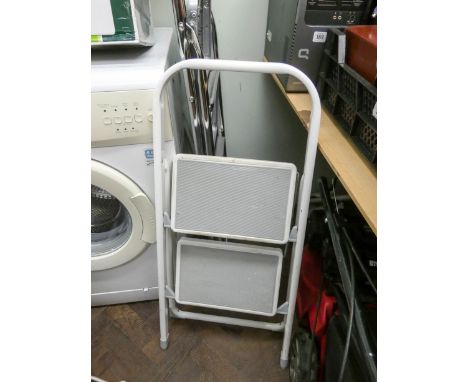 A pair of chrome finish step ladders and a white painted step up ladder 