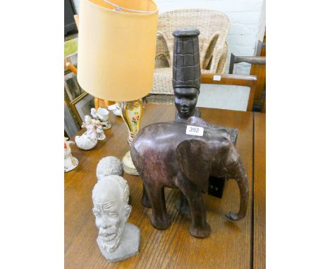 Carved African busts, two stone busts, carved wood elephant, lacquered trinket box and a painted table lamp 