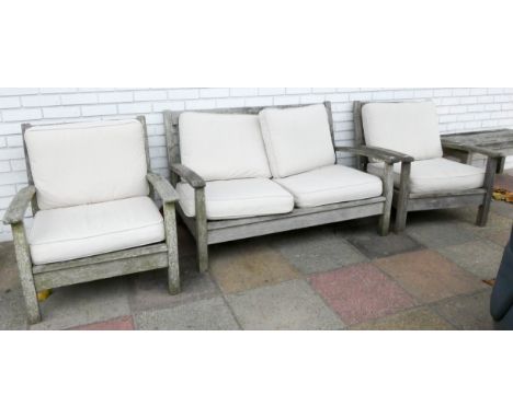 A heavy teak garden bench with faun coloured cushions and two matching chairs with side table 