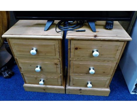 A pair of pine bedside cabinets with ceramic fittings