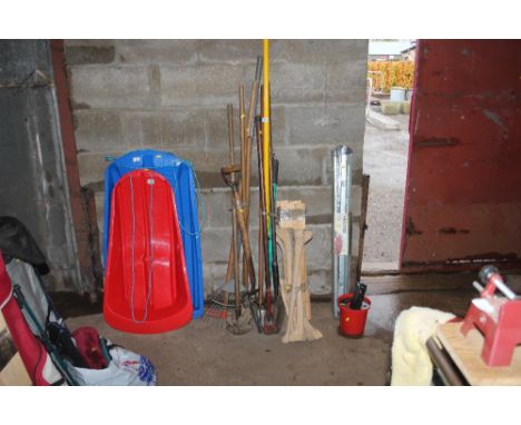 A quantity of long handled gardening tools; furniture legs etc