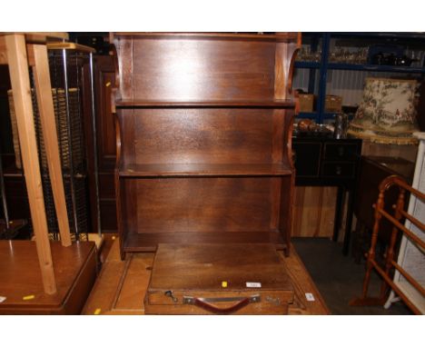 A wooden case together with a hanging shelf